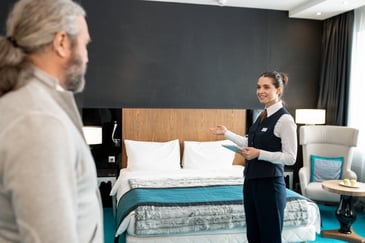 hotel employee presents room to guest